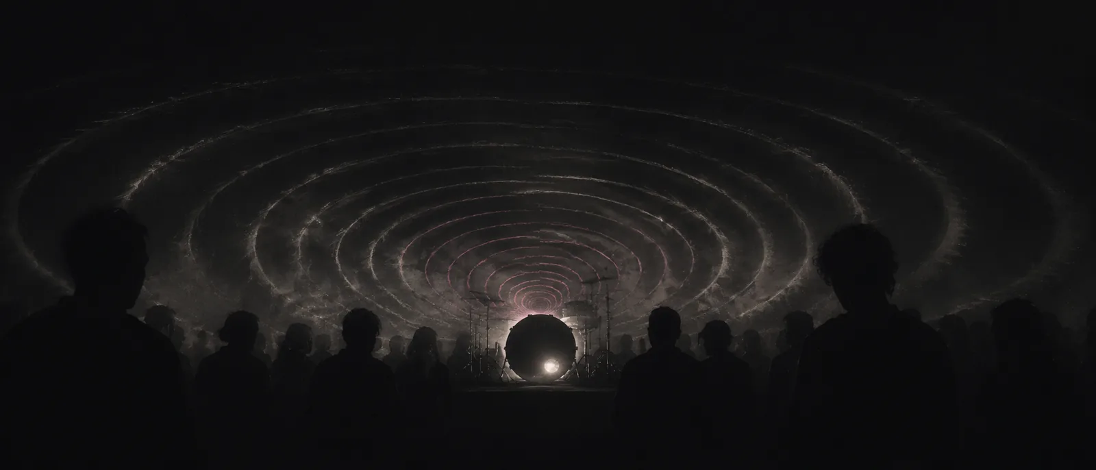 Sound pressure moving through a dark room: silhouetted crowd, concentric ripples off the stage.