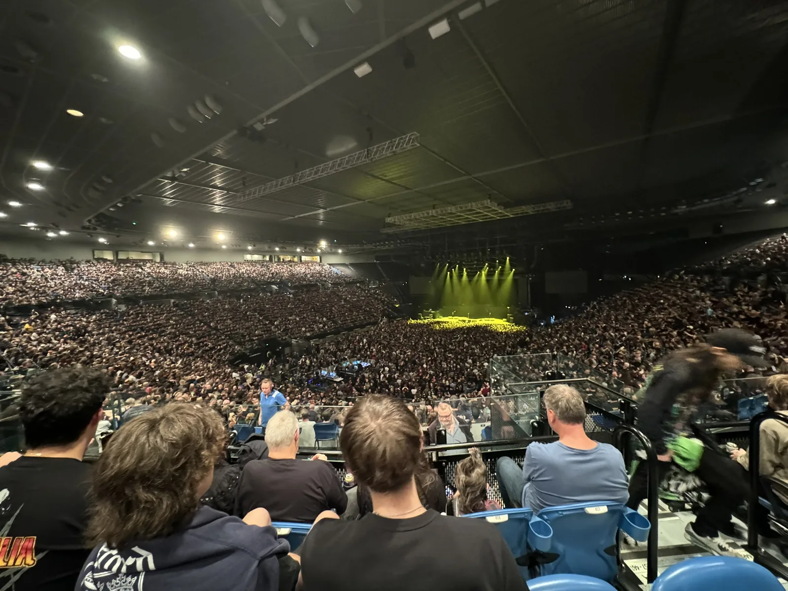 An arena crowd from the stands before a metal show.