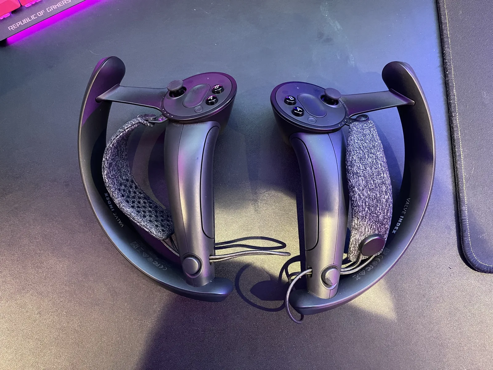 A pair of Valve Index controllers on a desk.