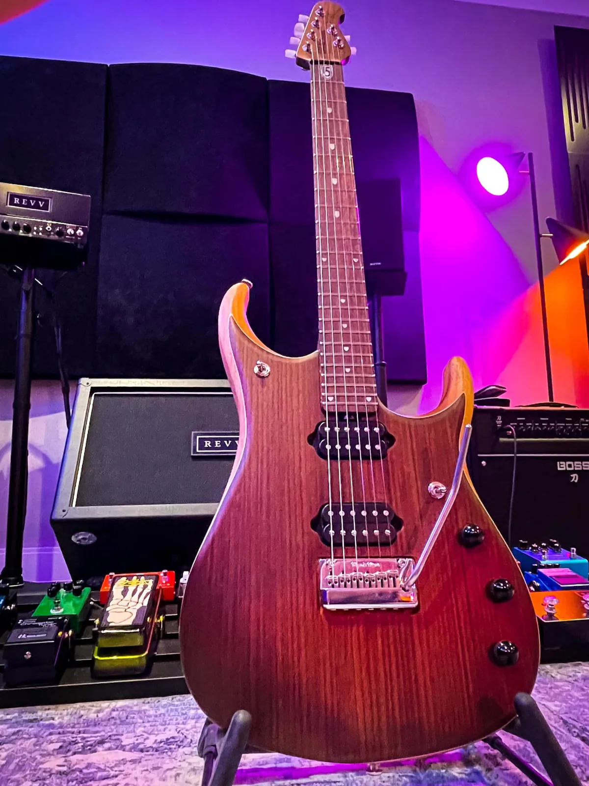 A Music Man JP15 in front of a REVV amp stack.