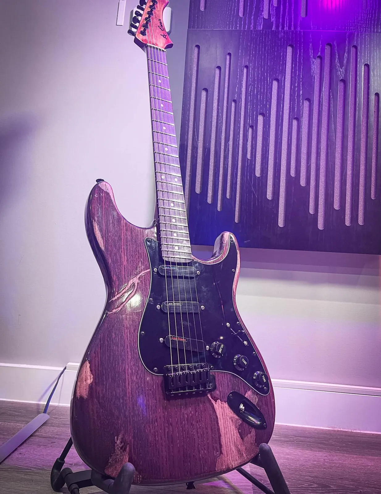 Purple guitar in a studio shot.