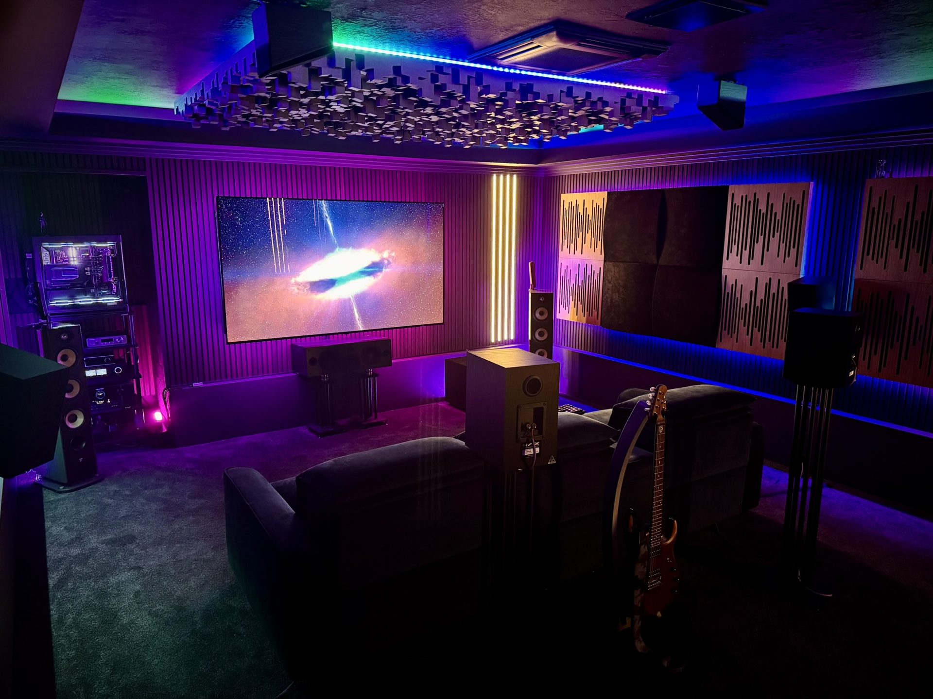 The rebuilt room: screen, speakers and lit acoustic ceiling.